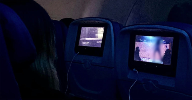 Censored image of Delta passenger watching the Delta-provided "Hustlers" movie in-flight
