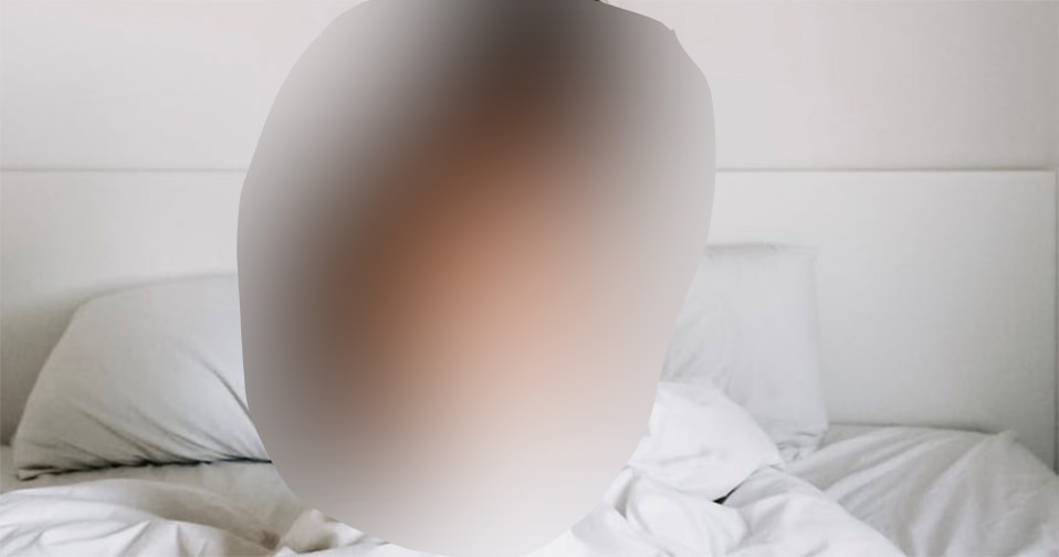 Blurred image of a person sitting on a bed representing the federal charges against Girls Do Porn for trafficking