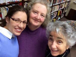 (L-R) Melody Bergman, Mary McAlister, and Dr. Judith Reisman posing in front of a portion of Judith's extensive library in her office at Liberty University.